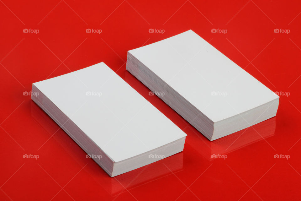 Business card mockup on red glossy background