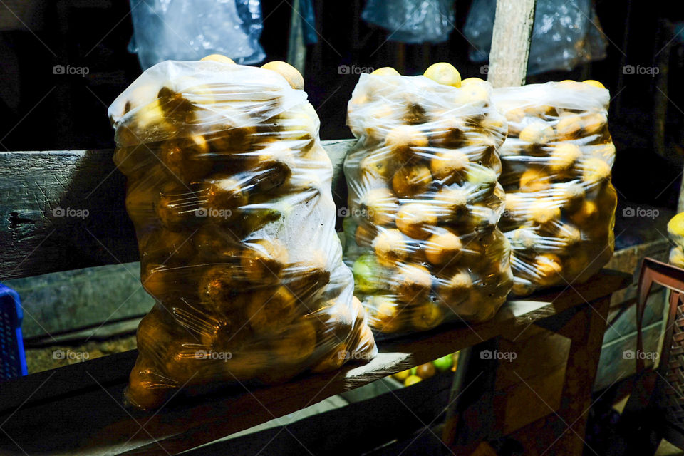 Oranges from the field for sale in plastic bags