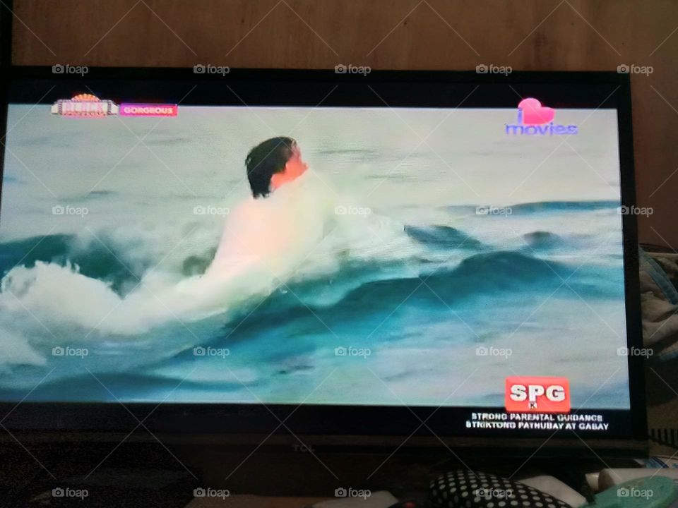 WATCHING MOVIE,, "GORGEOUS",  THE LEADING MAN AS PLAYED BY JACKIE CHAN,, IS BEING PULLED ALONG THE WATER