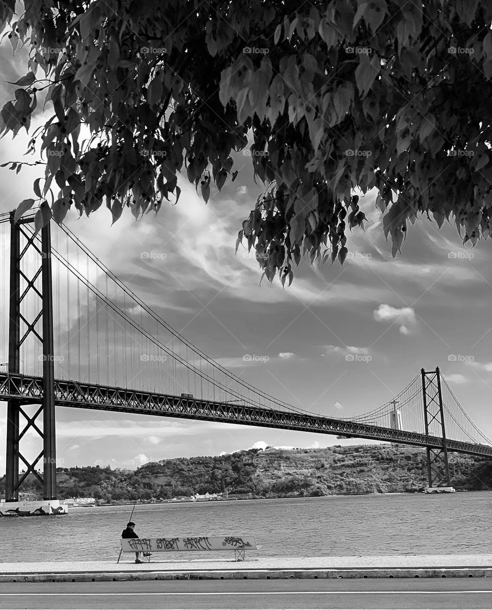 Fisherman by the bridge