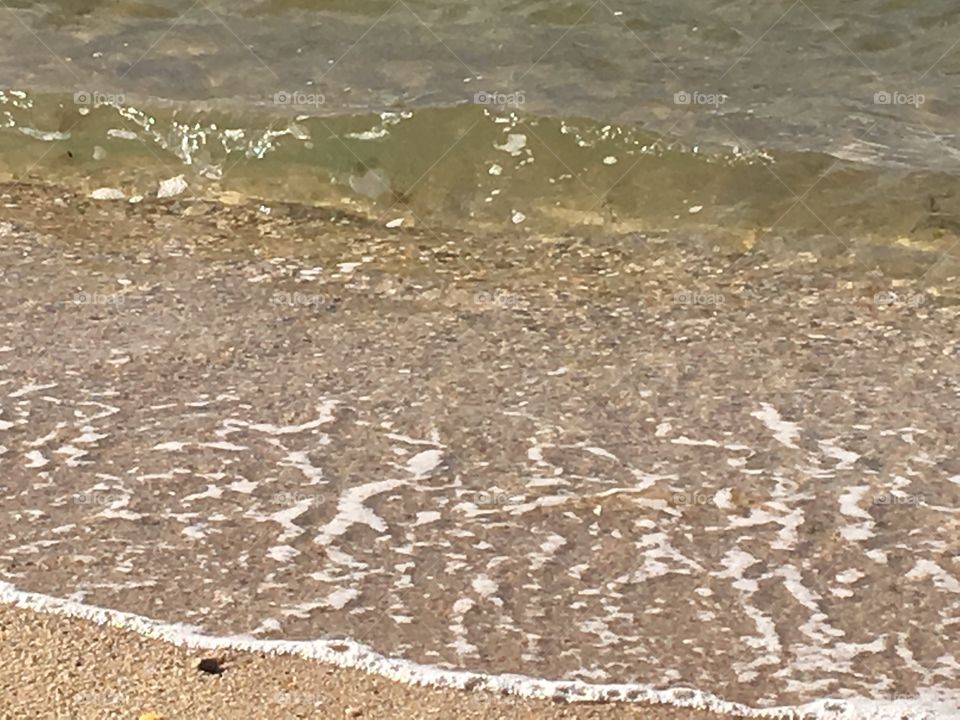 Moving waves crashing on the beach.