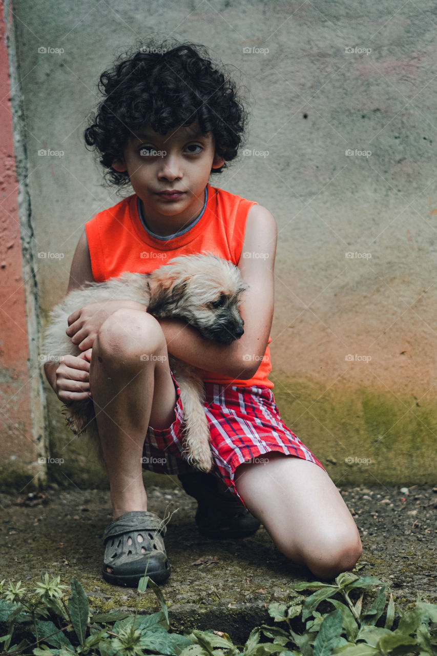 Child enjoying a moment with their pet. Kids playing with their dog