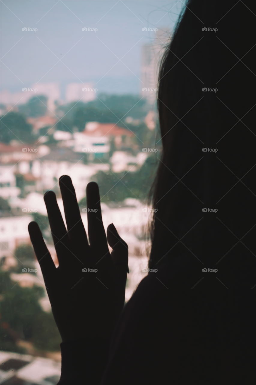 Close-up of a woman looking out from window 