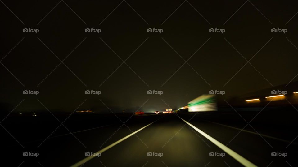 photo taken in the night along the highway by placing the camera on the dashboard of the car