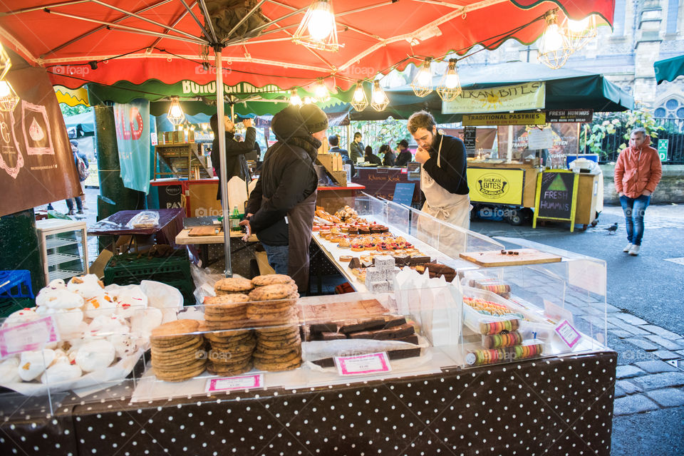 Food stand on the popular Borough Market in London. A food stand with cakes and cookies of various types.