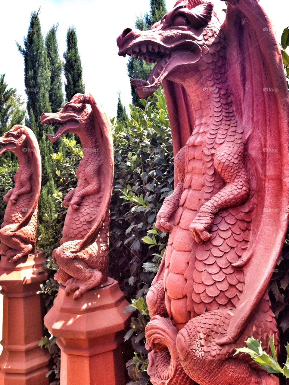 Guards of the maze. Stone Dragon sculptures in a garden maze