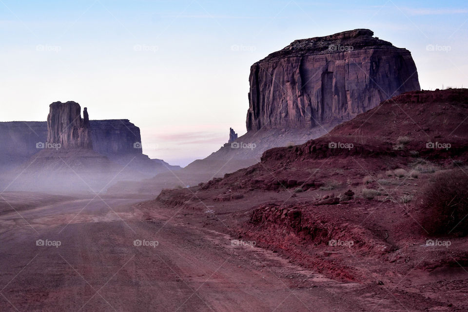 Drive through a sunlit valley in Monument Valley National Park