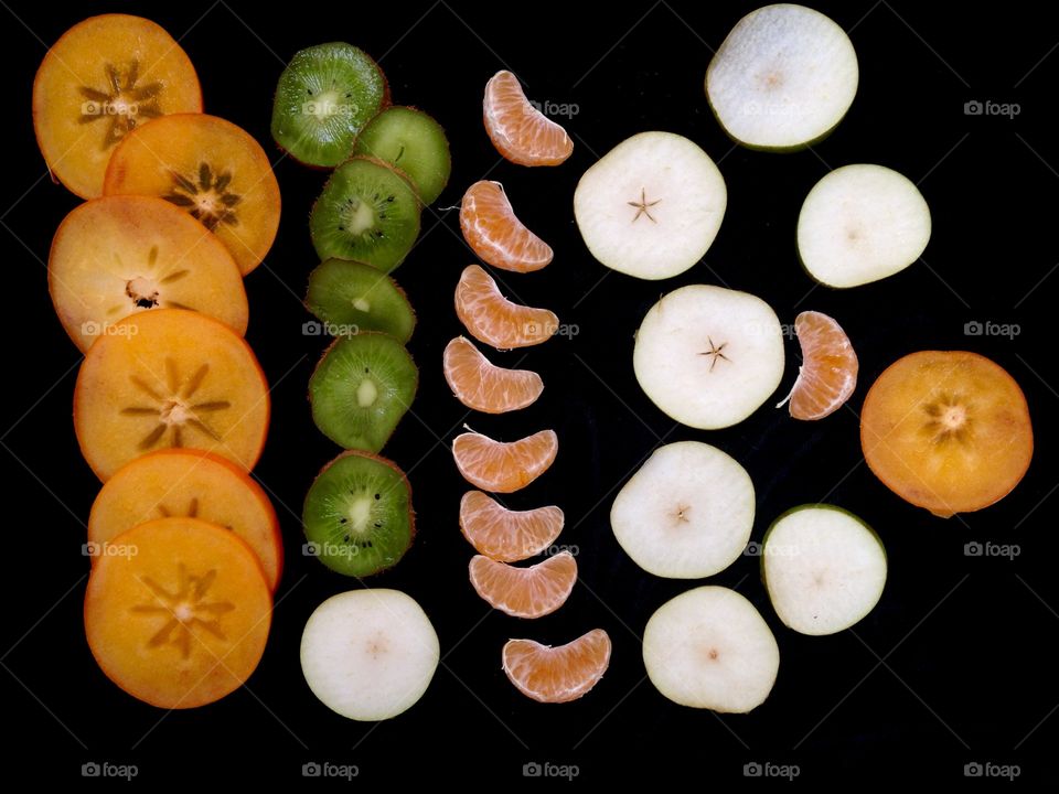 Fruits slices on black background 