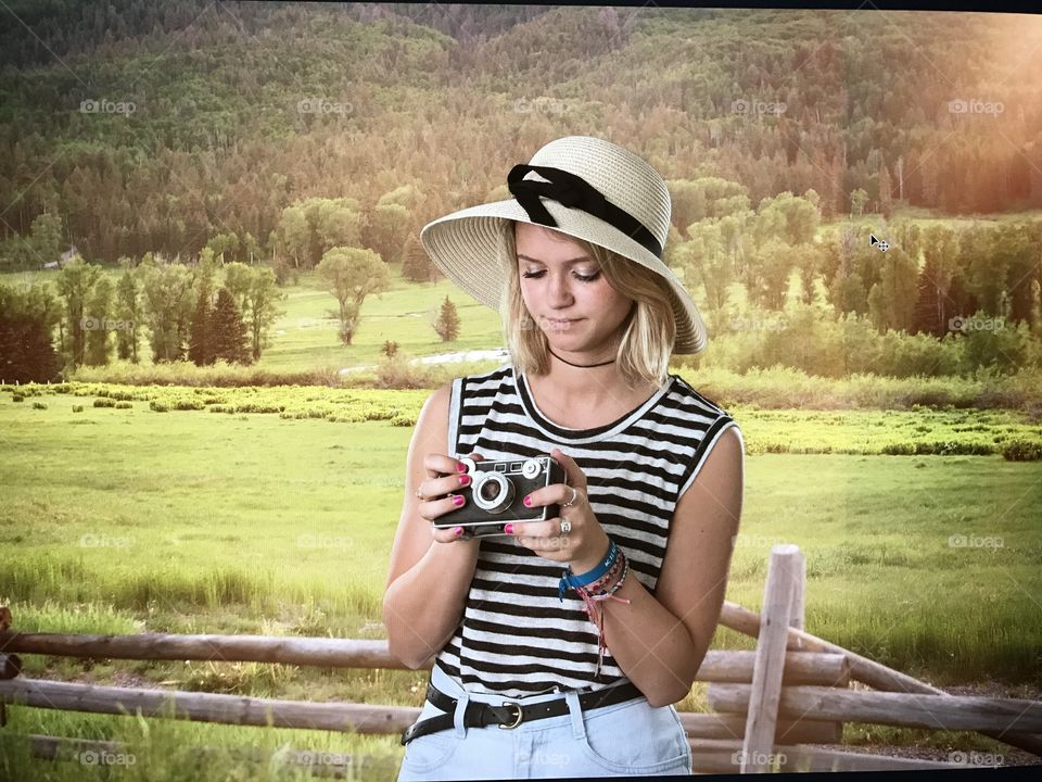 Girl holding vintage film camera outside 