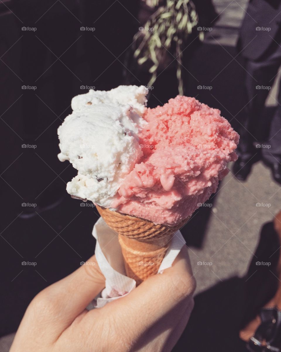 Person's hand holding Strawberry lemonade ice cream