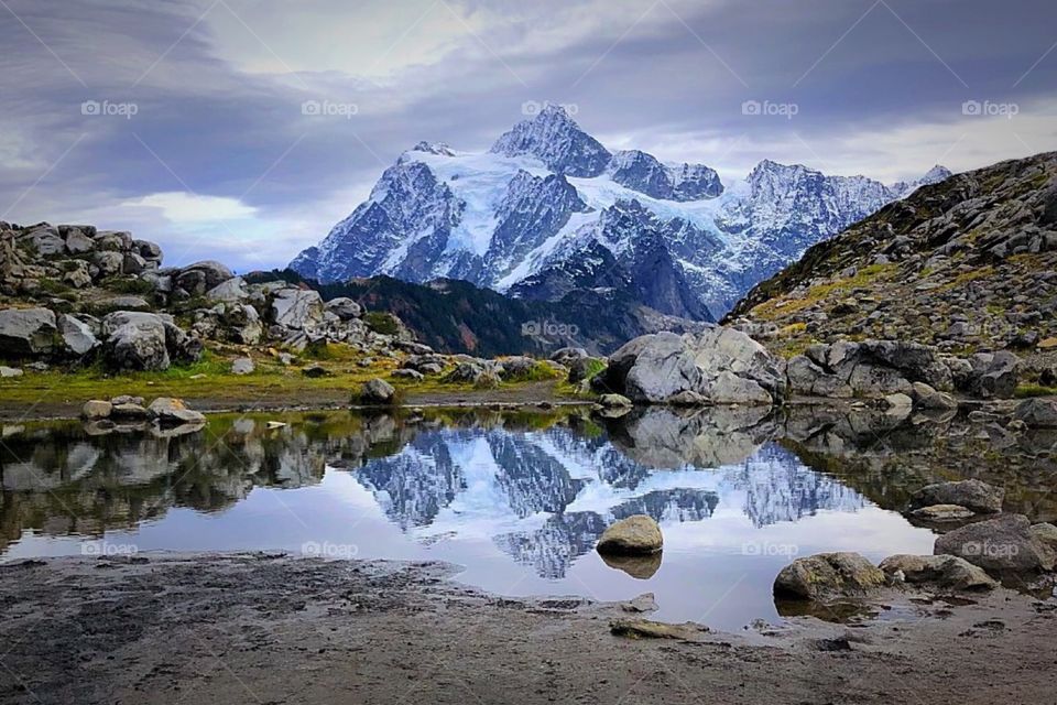 Mount Baker is reflected in glacial waters on a crisp Autumn day in Washington State