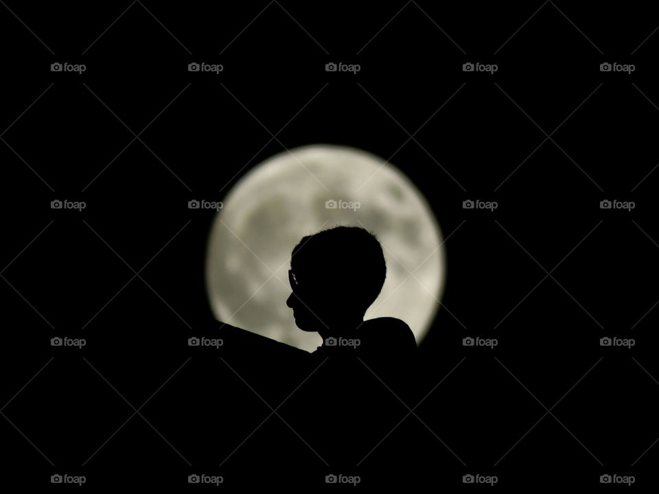 My brother with the moon behind him