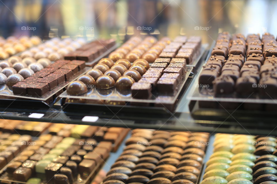 Chocolate in lines in a shop full of tasty pralines 