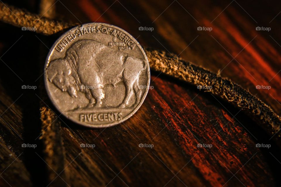 Buffalo nickel on a wood surface 