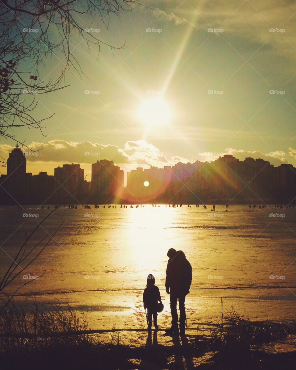 Father with son at sunset 