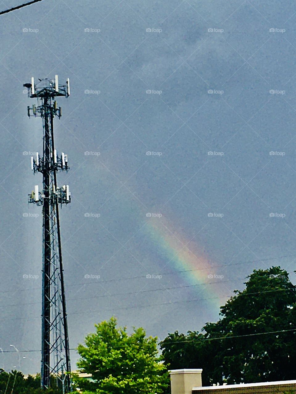 Rainbow next to a tower 