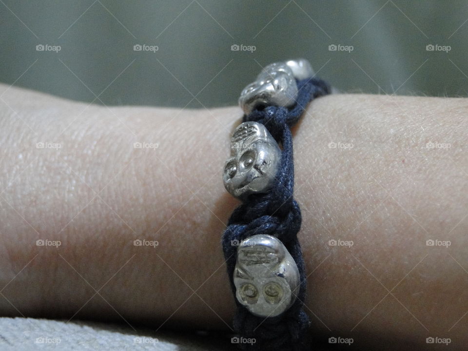 black bracelet with skulls