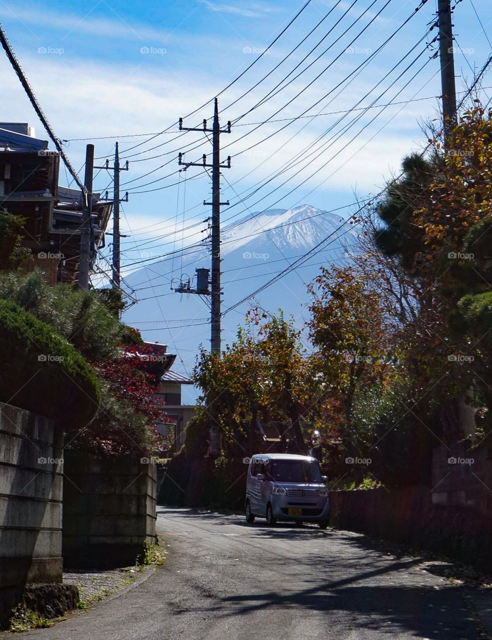 Mt Fuji seen down a quiet and calm street in Kawaguchiko, Japan.