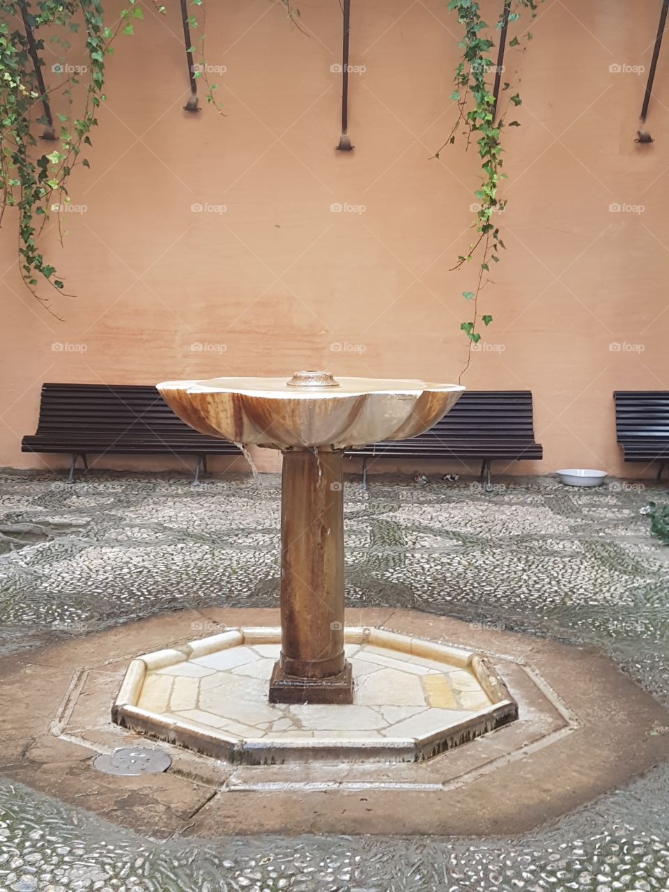 Lovely courtyard with a fountain in the center. Alhambra, Granada, Spain.