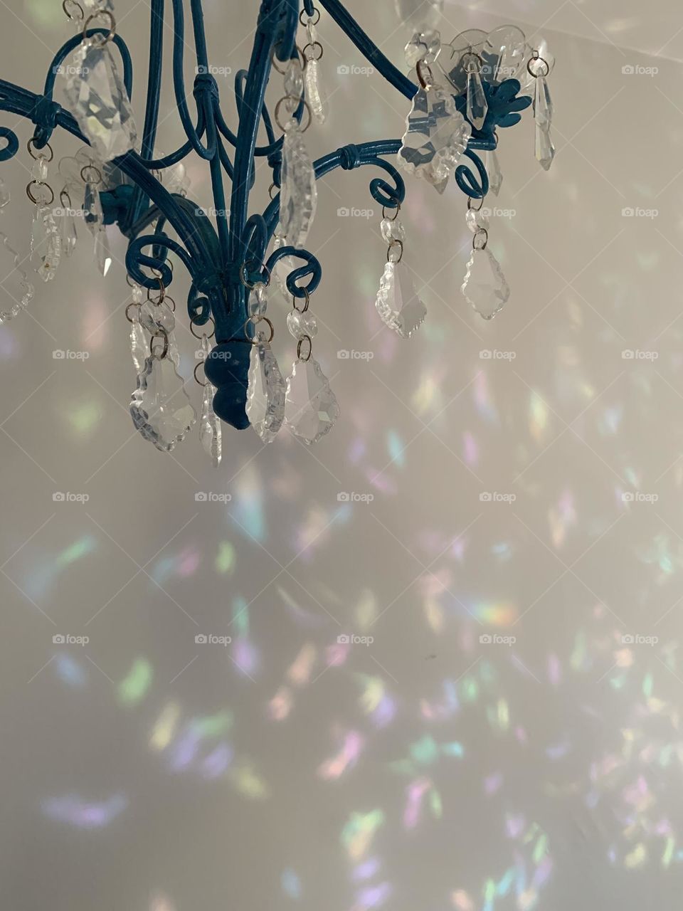 Chandelier crystals making a rainbow on the wall 