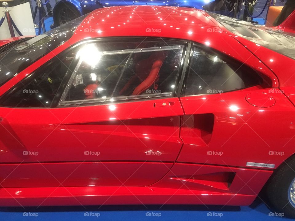 Side view of a red Ferrari F40 sports car, at the London Classic Car Show, Excel, London, in Winter. 