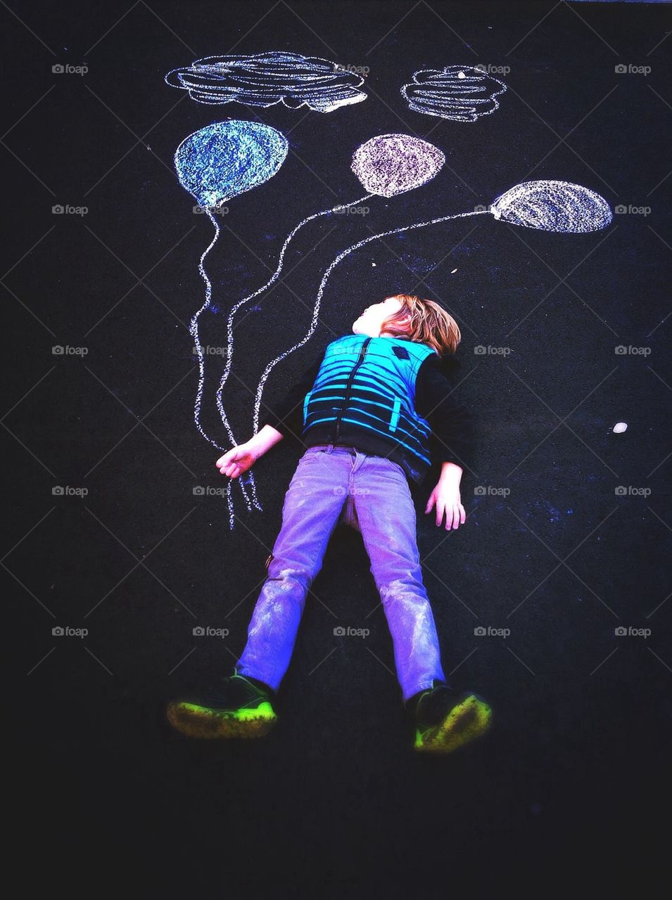 Boy holding chalk balloons