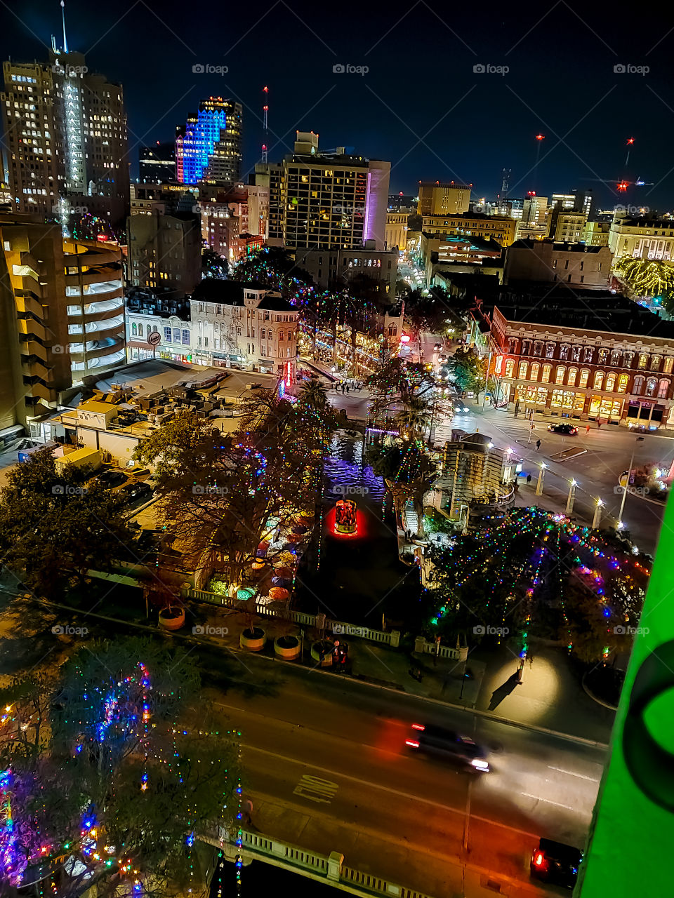 Downtown city lights at night with a vibrant view from a high rise during holidays.
