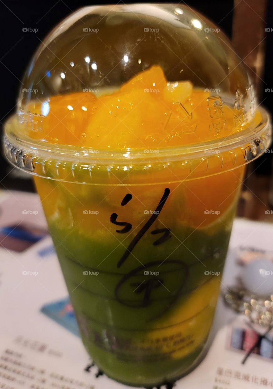 starbuck Mango Matcha Freeze.A drink made of matcha and mango jelly in a plastic cup.