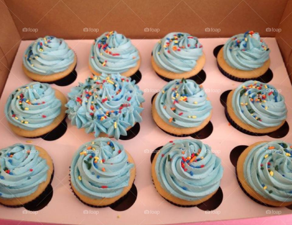 Birthday cupcakes for a boy with blue icing and sprinkles.