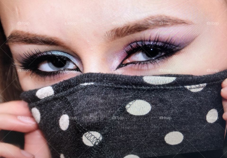 Young woman wearing polka dot face mask