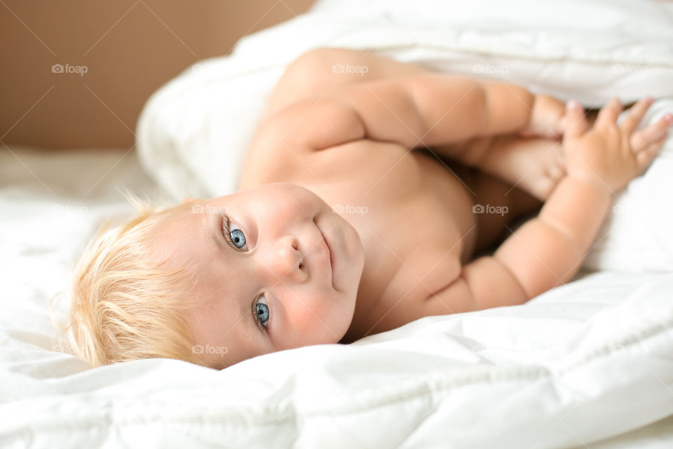 Cute baby playing on bed