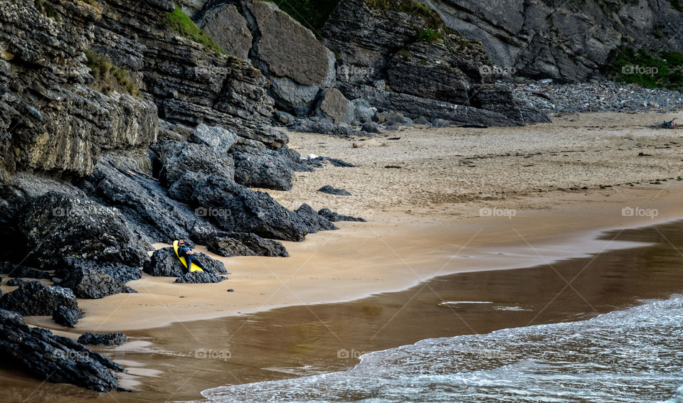 A surfer rests on his surfboard  after Surfing 