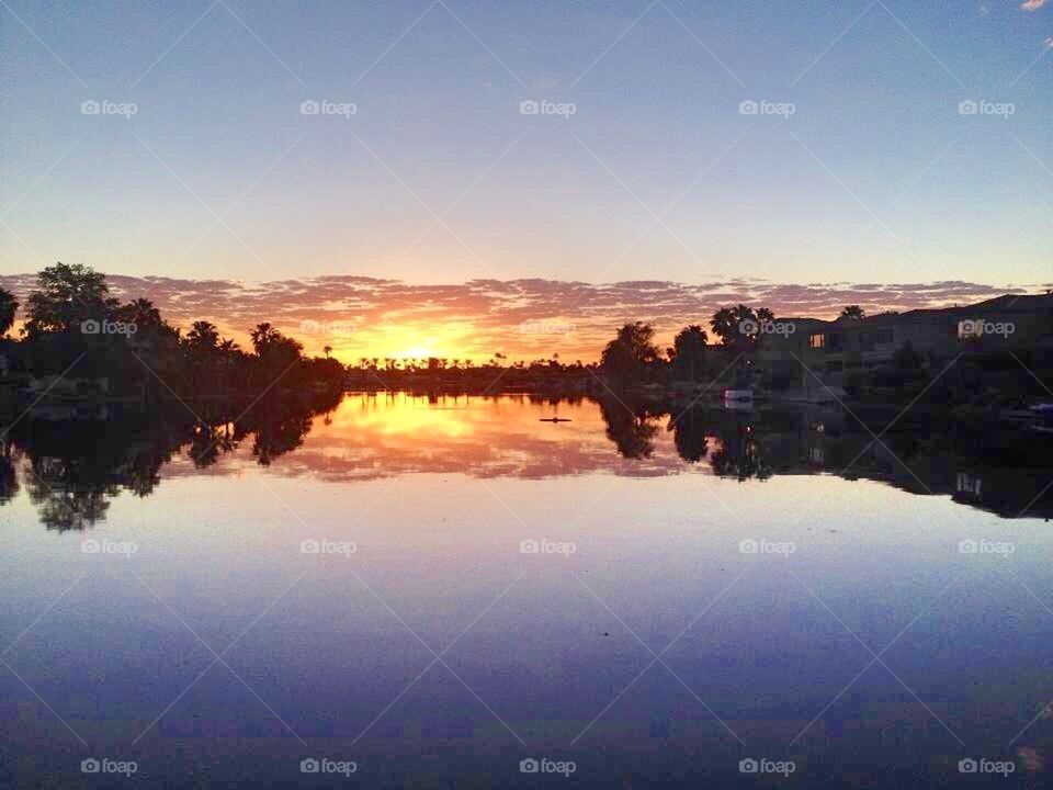The sunset over the calm lake 