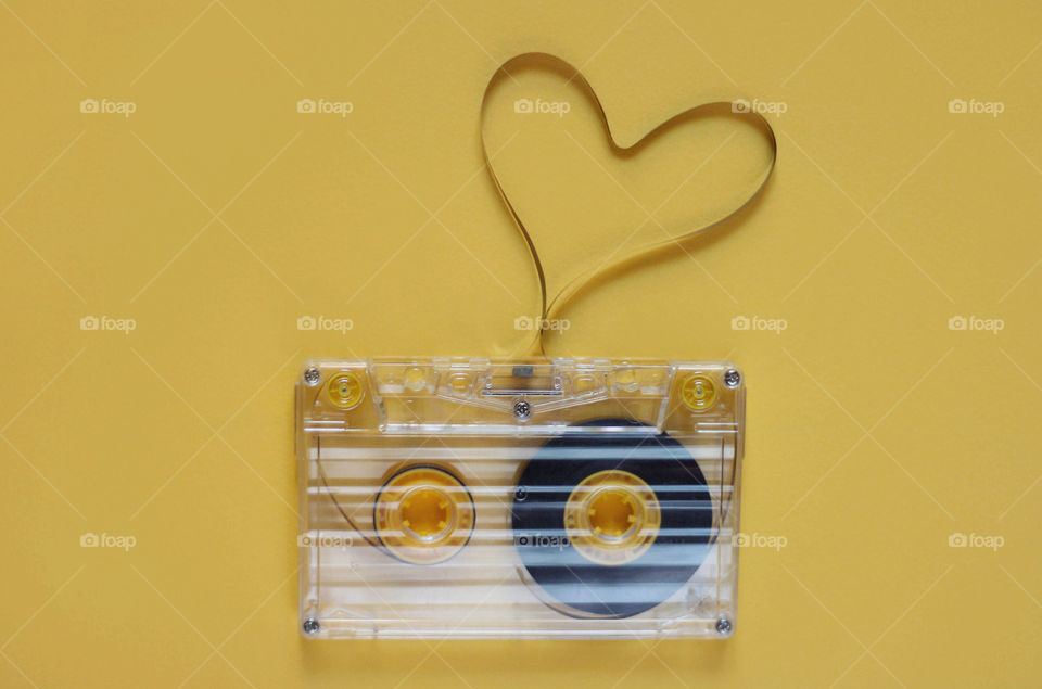 Music retro tape, heart shape, yellow background