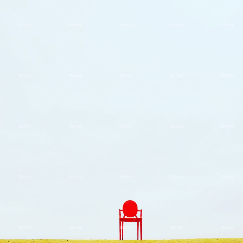 Red chair on grassy land