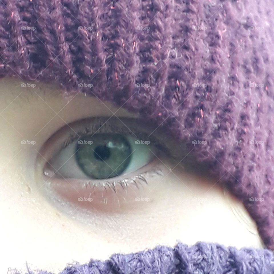 green eye of life girl  in purple winter hat