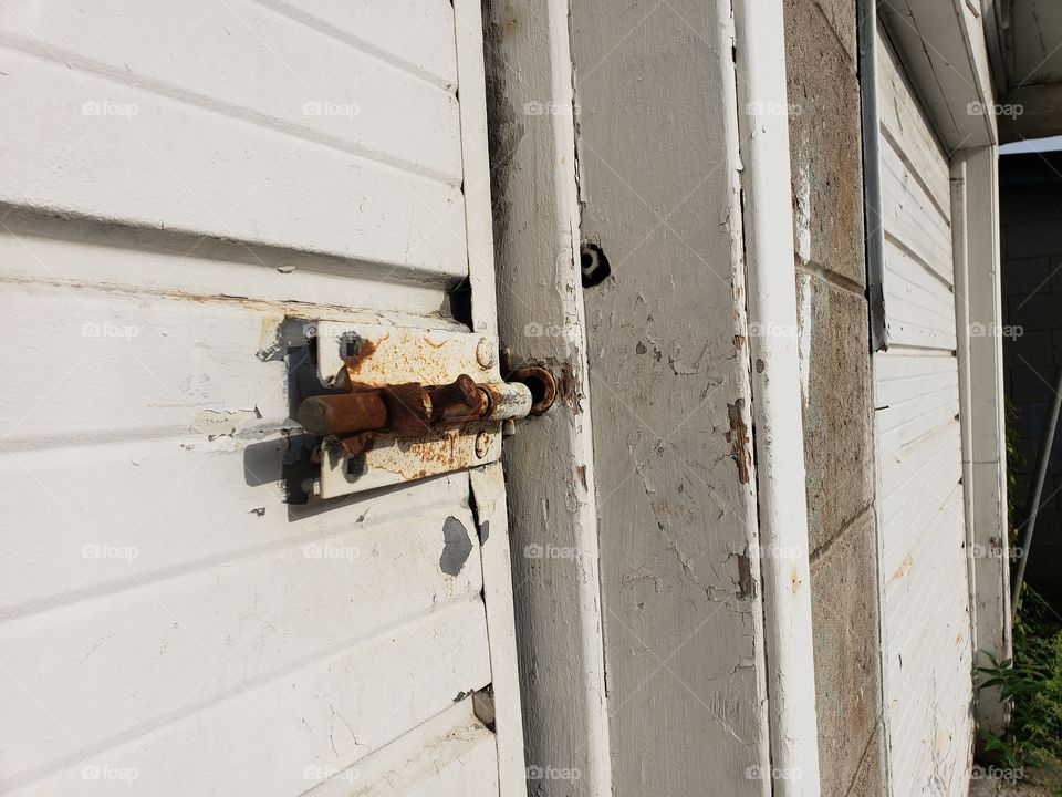 old deadbolt lock on a garage door