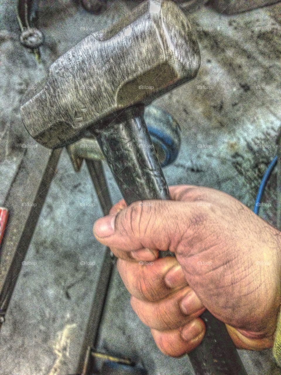 Close-up of blacksmith hand holding hammer