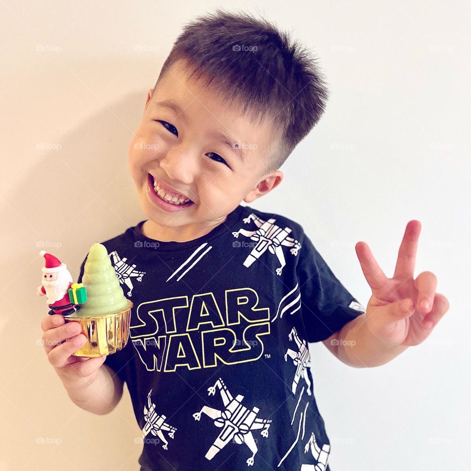 Asian boy with agar jelly cupcake smiling 