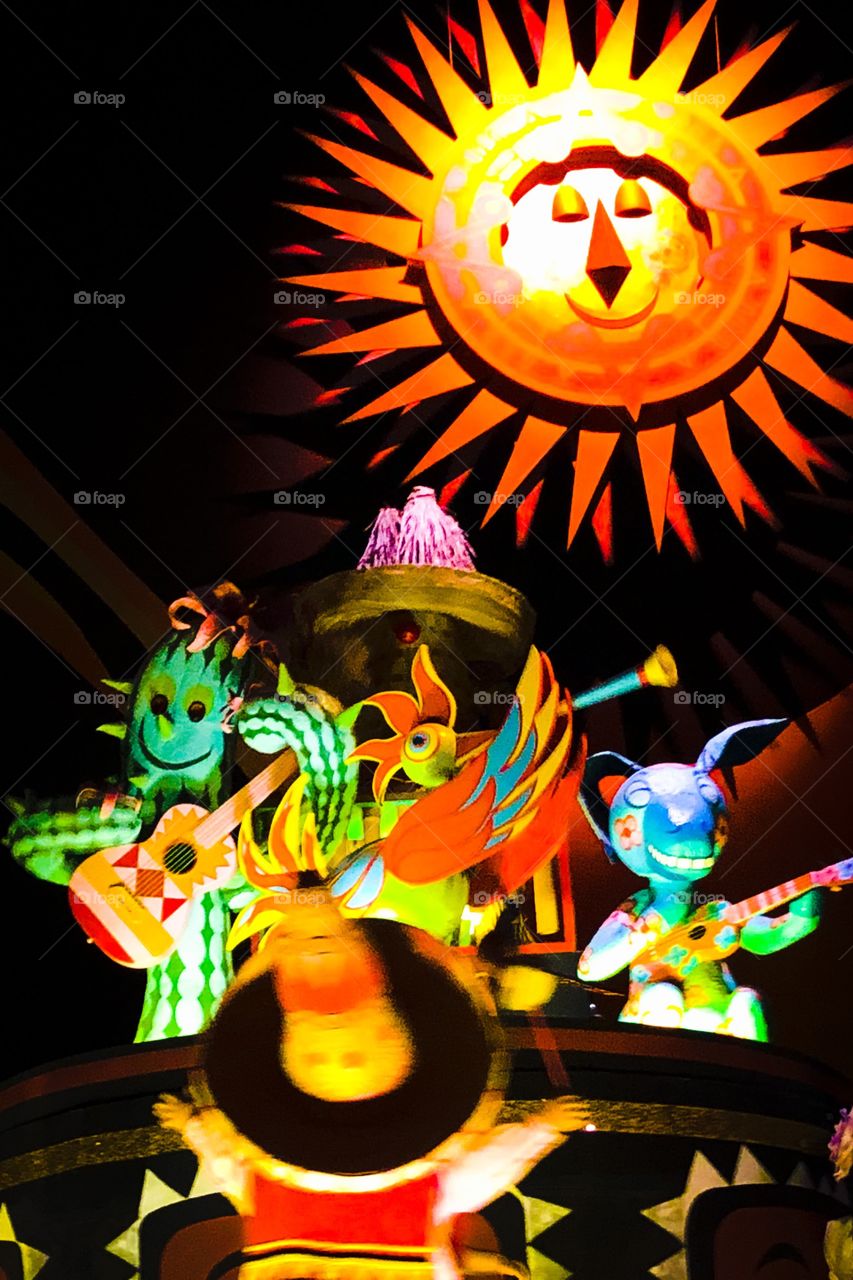 Sunset behind the cactus playing guitar in “It’s a small world!”