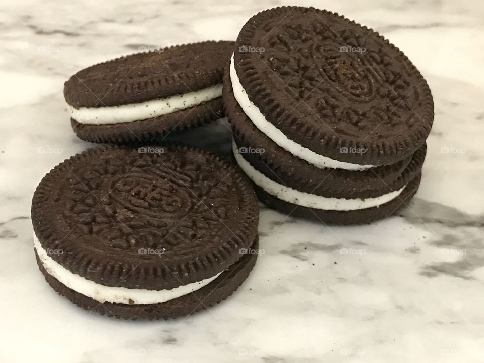 Pile of chocolate double stuffed Oreo cookies on a marble background