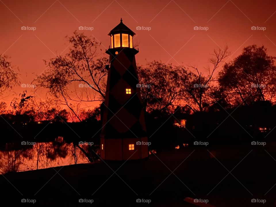 Majestic Lighthouse reflections from inside light globe from Beautiful perfect Backlit Orange Glow of the Twilight very near to Captivating this Sunset soon to be Night. 