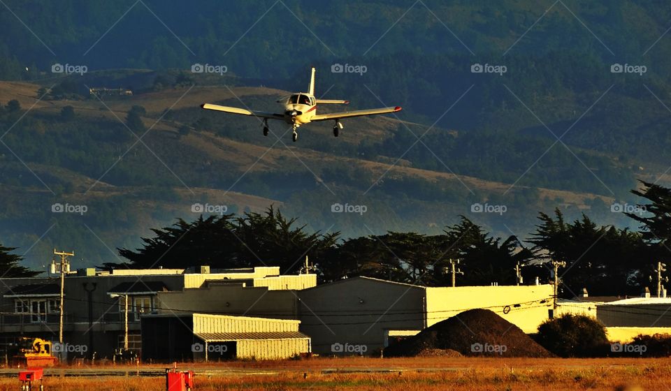 Aircraft Landing Before Sunset. Aviation During The Golden Hour
