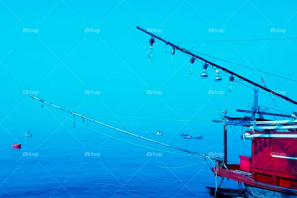 fishing trawler docked at shore