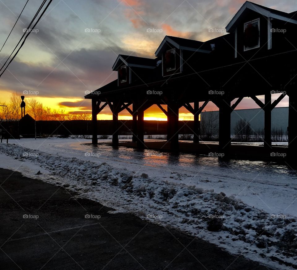 Sunset on Main Street with old car works in back