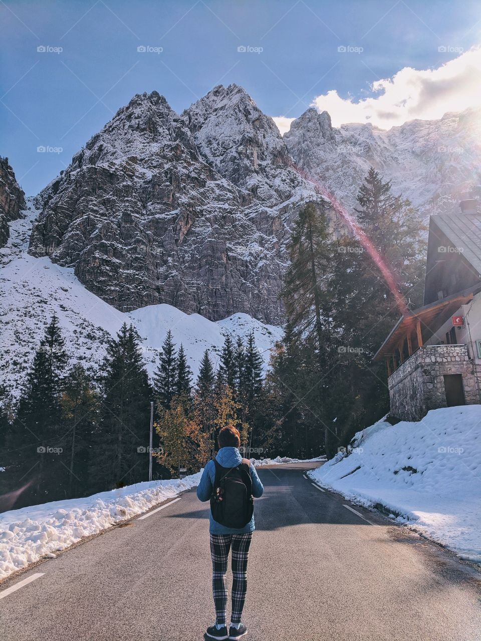 Young happy woman traveler against the snow covered Alps mountains in Slovenian trip.