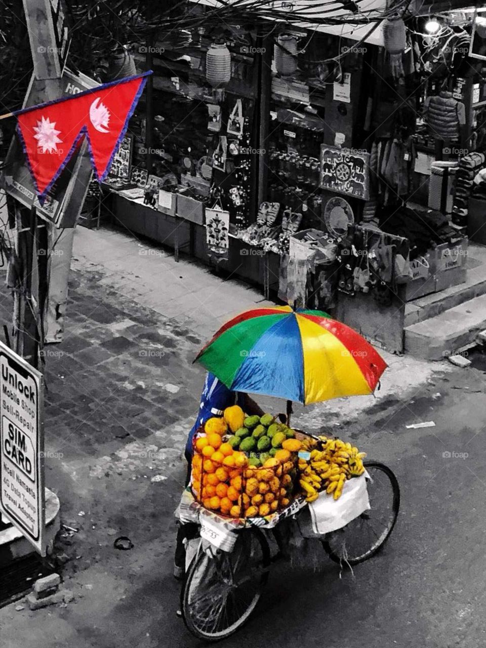 Selling fruits on street during rain, struggling to have better life.