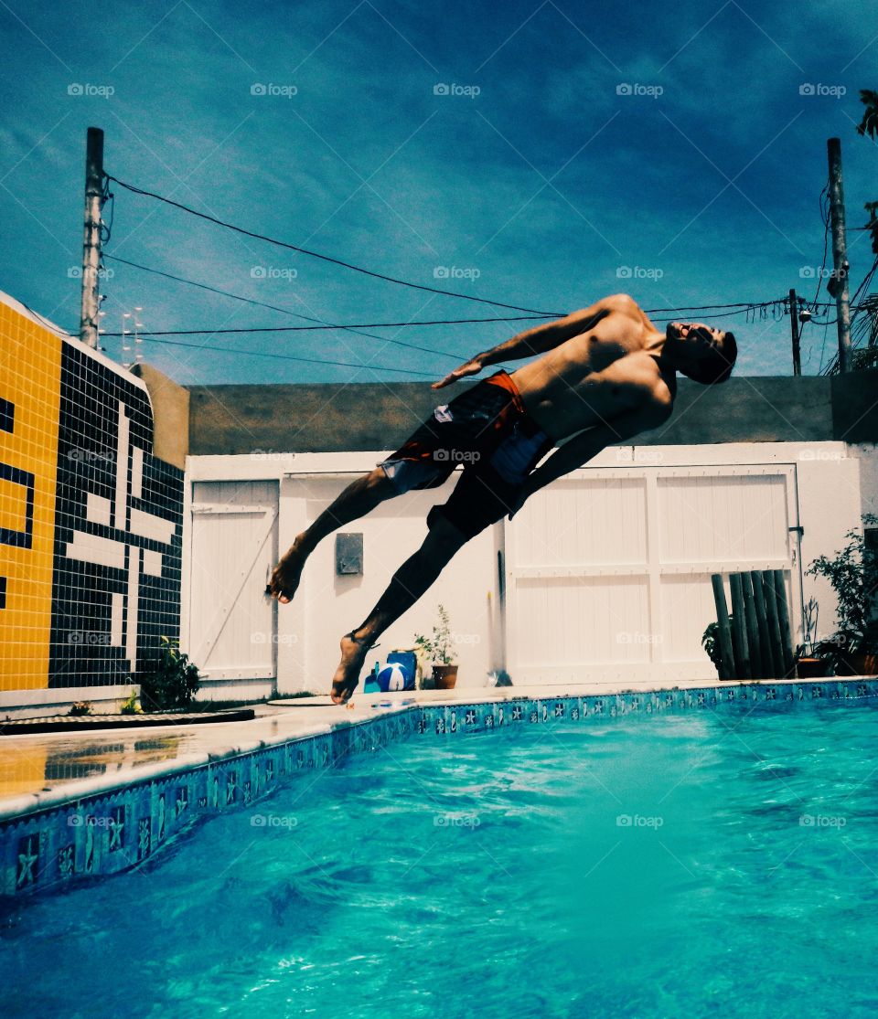 Young man diving in swimming pool