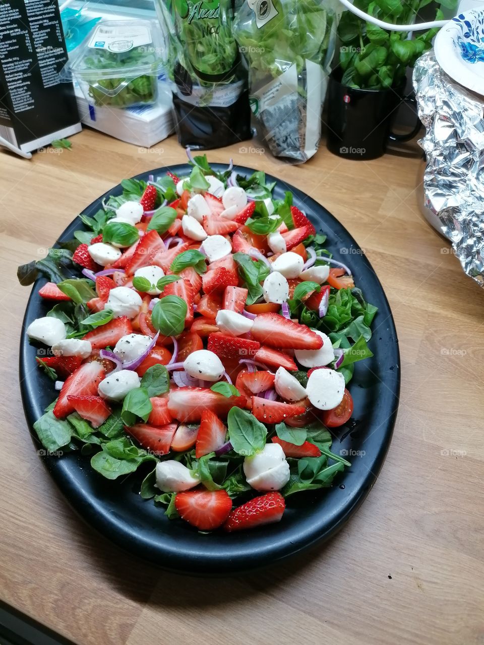 Homemade really delicious summer salad with strawberries, mozzarella, basil, arugula, nuts, red onion and black pepper. Is good! I recommend!