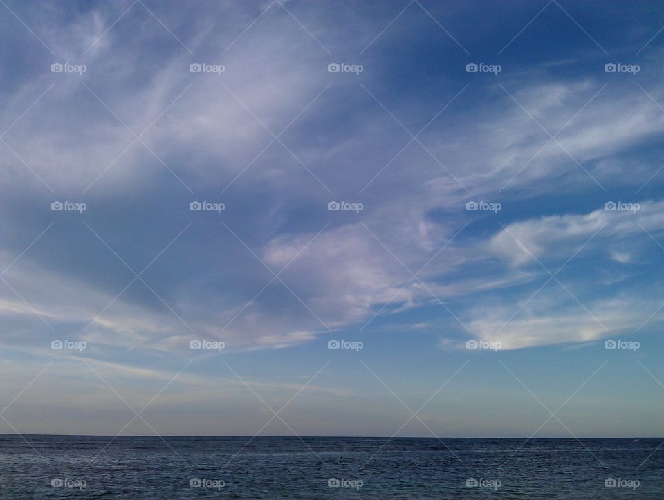 blue sky and clouds over the ocean. sea coast sky and clouds